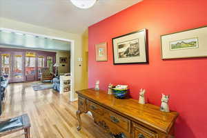 Corridor featuring light wood-type flooring and baseboards