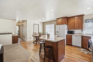 Kitchen and dining area with hardwood flooring