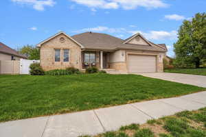 Front of home with brick and stucco siding and RV parking