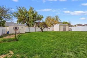 Fenced backyard with 2 sheds