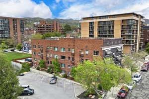 View of apartment building / complex with uncovered parking and a mountain view