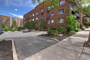View of apartment building / complex with uncovered parking
