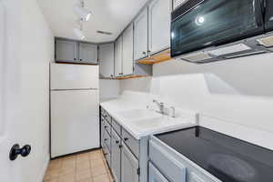 Basement kitchenette with stove and sink