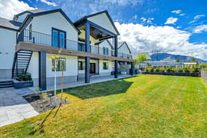 Back of house featuring a patio, a mountain view, and stucco siding