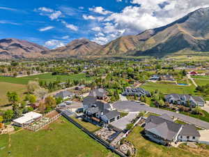 Aerial overview of property's location featuring a mountainous background and nearby suburban area