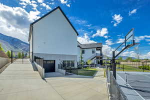 View of sport court featuring a mountain view, a gate, and basketball court