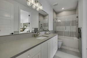Ensuite bathroom with vanity and enclosed tub / shower combo