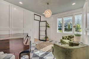 Office featuring a decorative wall and a chandelier