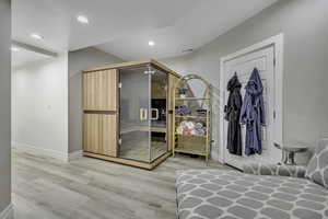 Bedroom featuring light wood-style flooring, recessed lighting, and a relaxing sauna