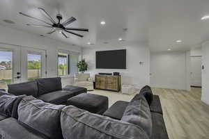 Living area with light wood-style flooring, french doors, a ceiling fan, and recessed lighting