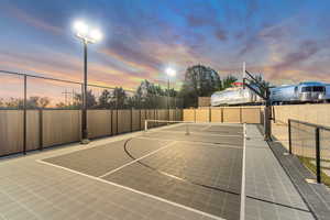 View of sport court featuring basketball hoop and a tennis court