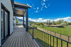 Deck with a residential view and a mountain view