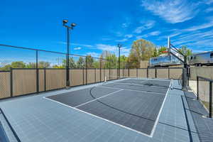 View of sport court with basketball hoop and a tennis court
