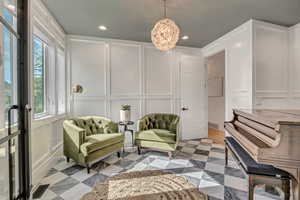 Living area featuring a decorative wall and recessed lighting