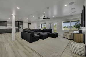 Living area with light wood-type flooring, recessed lighting, ceiling fan, and french doors