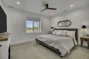 Bedroom with a ceiling fan, recessed lighting, and light colored carpet