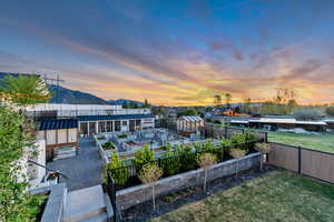 Exterior space with a garden, a mountain view, an outdoor structure, an exterior structure, and a patio
