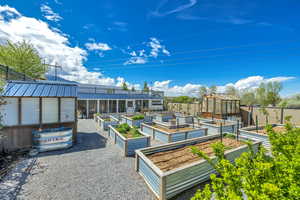 View of home's community with an outdoor structure, an exterior structure, and a patio area