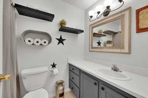 Bathroom featuring a shower with curtain and vanity