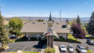 View of building exterior with uncovered parking and a mountain view