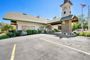 View of property with uncovered parking