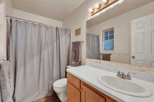 Bathroom featuring vanity and curtained shower