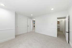 Spare room featuring light carpet, recessed lighting, and crown molding