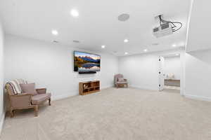 Sitting room featuring recessed lighting and light colored carpet