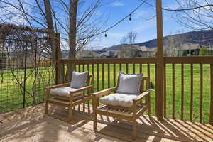 Wooden deck with a residential view and a yard
