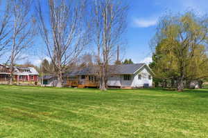 Full view of flat, usable 1-acre lot with green lawn, open space, and fencing