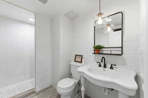 Full bathroom with tile walls and walk in shower