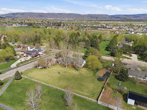 Aerial view of property's location with a mountainous background and nearby suburban area