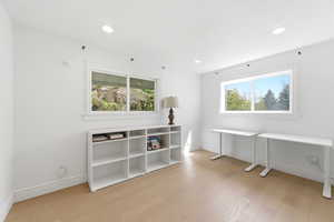 Unfurnished office with light wood-style floors and recessed lighting