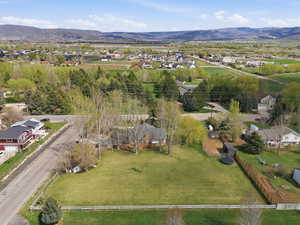 Aerial overview of property's location with a mountain backdrop and nearby suburban area