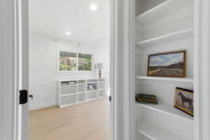 Detailed view of wood finished floors and recessed lighting