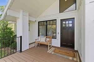 Entrance to property featuring stone siding