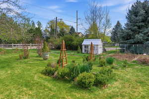 Garden and chicken coup in fenced yard