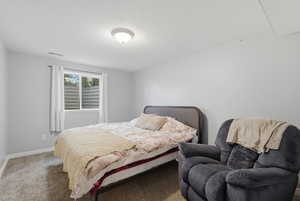 Bedroom with carpet and a textured ceiling