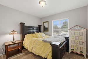 Bedroom featuring dark carpet