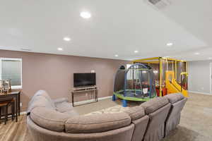 Living room with recessed lighting and baseboards