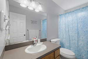 Bathroom with vanity and curtained shower