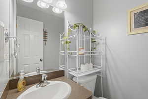 Half bathroom featuring toilet and vanity