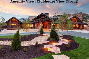 View of front of home featuring a standing seam roof, stone siding, and a chimney