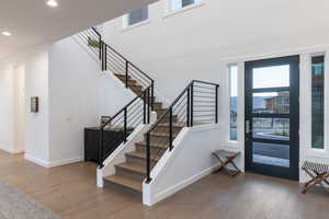 Foyer entrance featuring healthy amount of natural light, dark wood finished floors, and recessed lighting