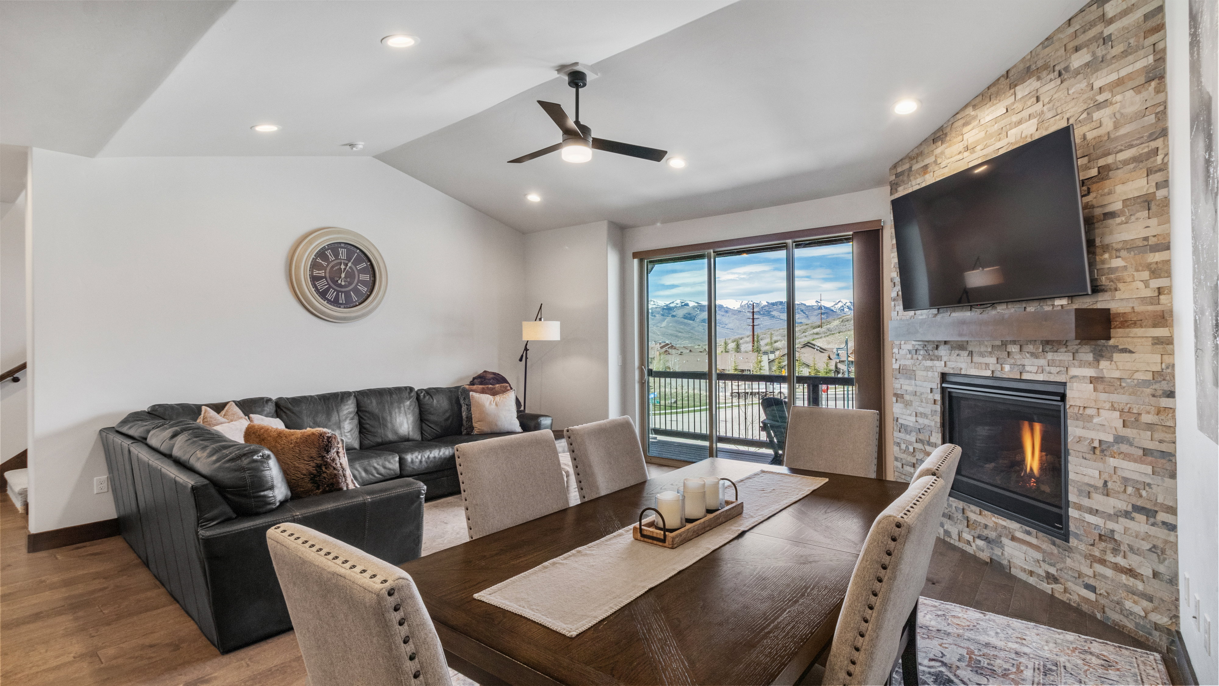 Dining area featuring a fireplace, ceiling fan, wood finished floors, and recessed lighting