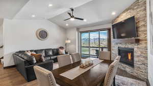 Dining area featuring a fireplace, ceiling fan, wood finished floors, and recessed lighting