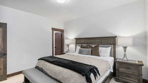 Bedroom featuring light carpet