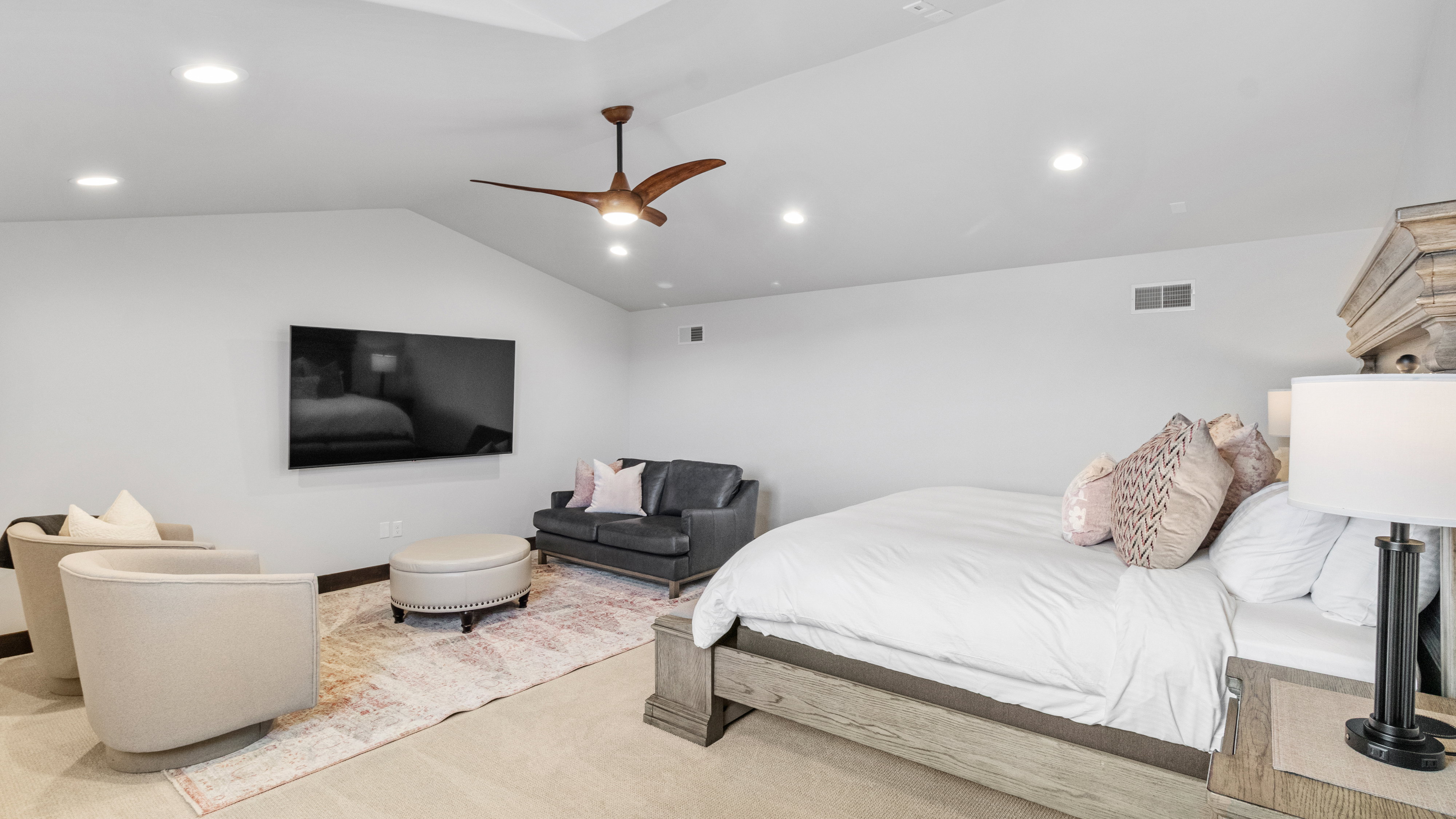 Carpeted bedroom with ceiling fan, recessed lighting, and vaulted ceiling