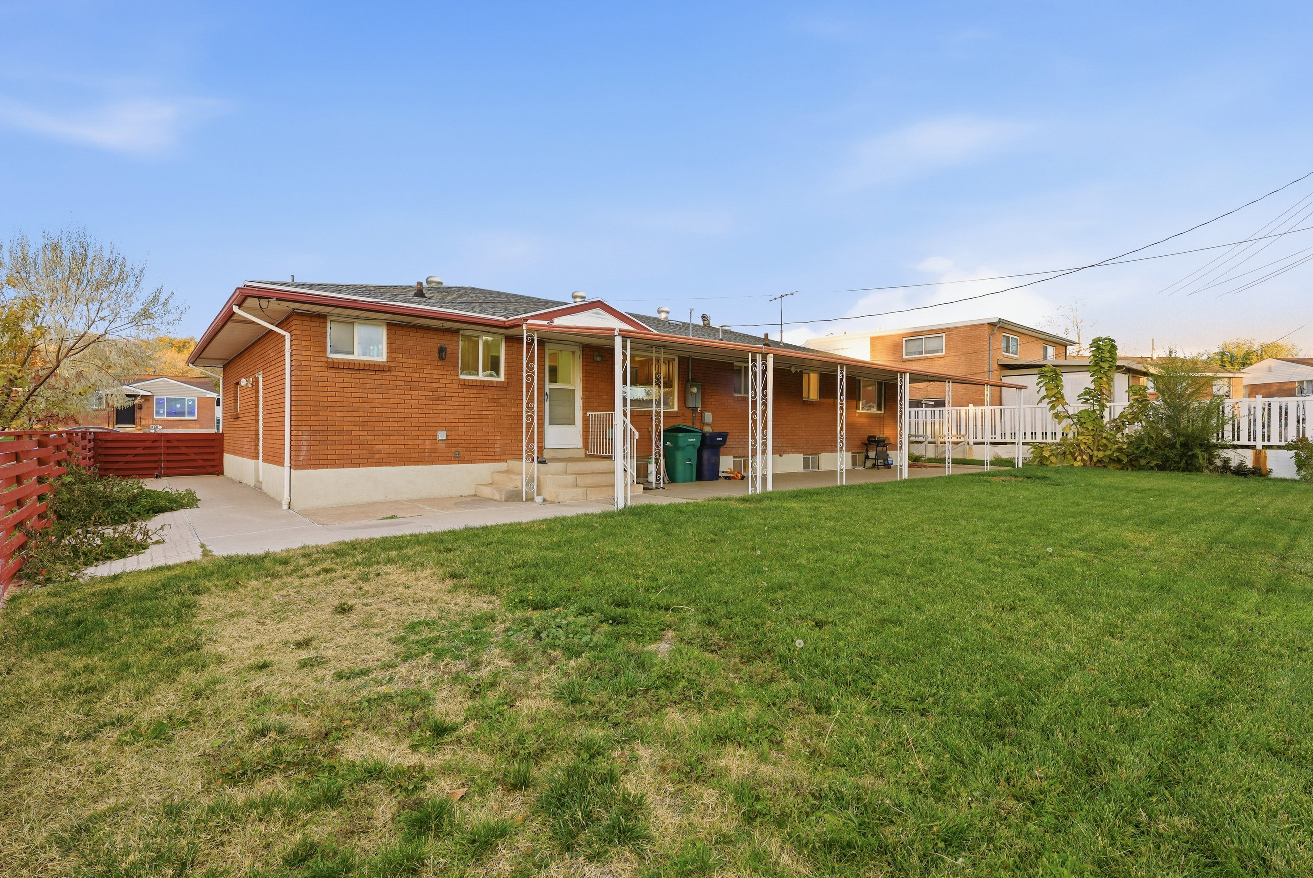 Back of property featuring a fenced backyard, a patio area, brick siding, and entry steps