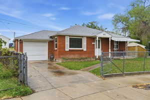 View of front of property featuring a shingled roof,  gate, driveway, an attached one car garage, and a fenced front yard